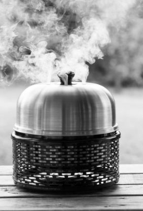 Cobb PRO sitting on garden table hot smoking food