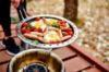 Sausage, eggs and tomatoes cooked in the Cobb fry pan on garden decking