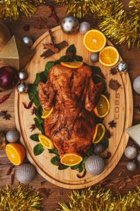 Festive roast chicken on top of Cobb Supreme Bamboo Cutting Board