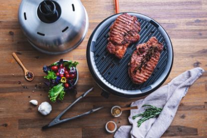 steak cooking on Cobb griddle